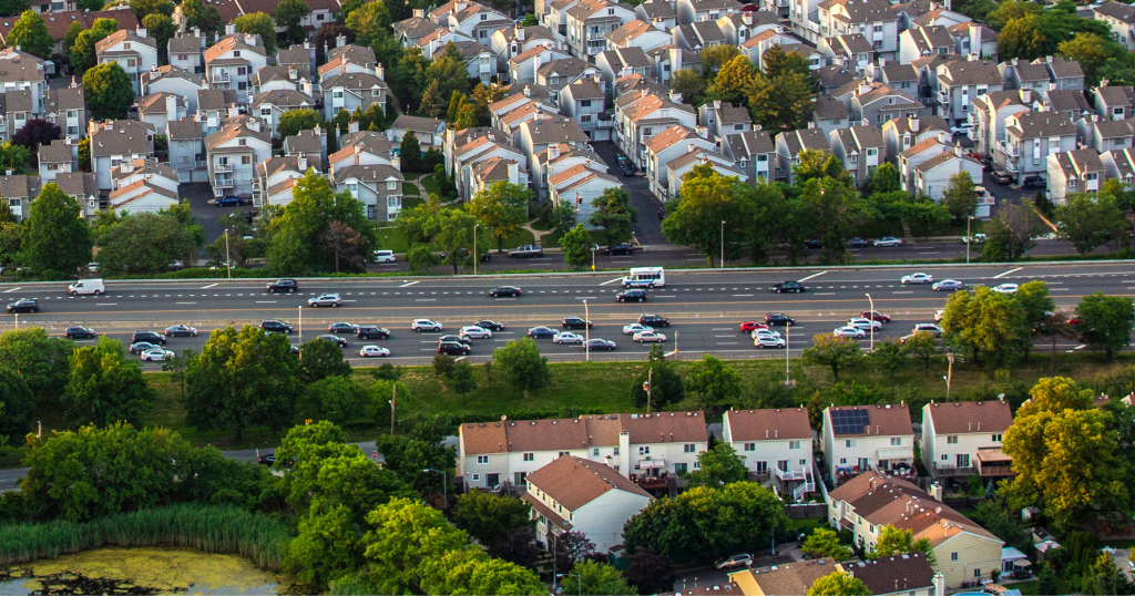 A motorway surrounded by houses.