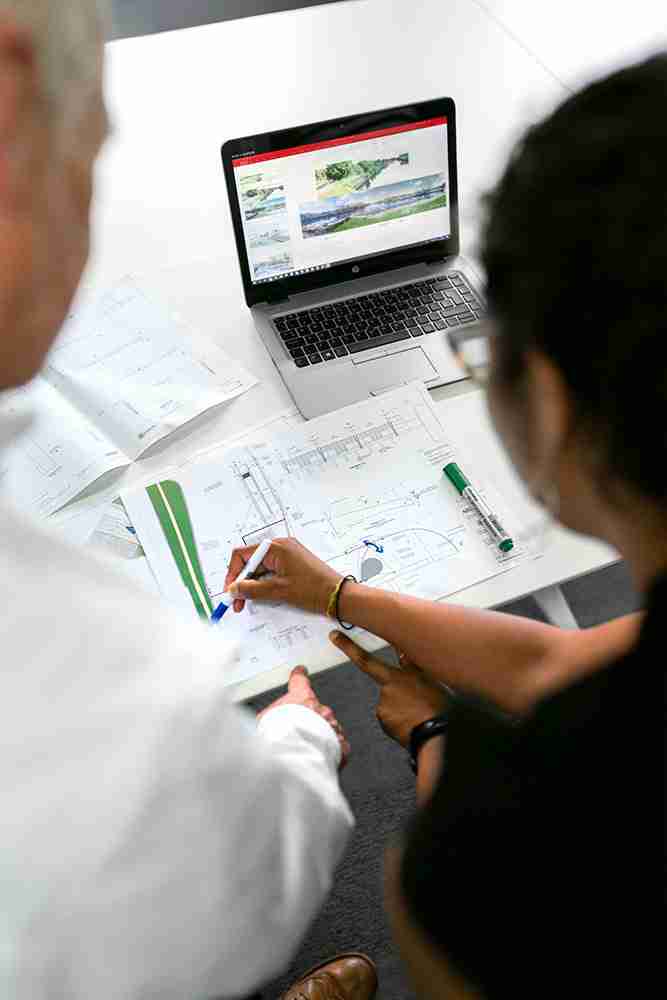 Man and a woman looking at a laptop while discussing