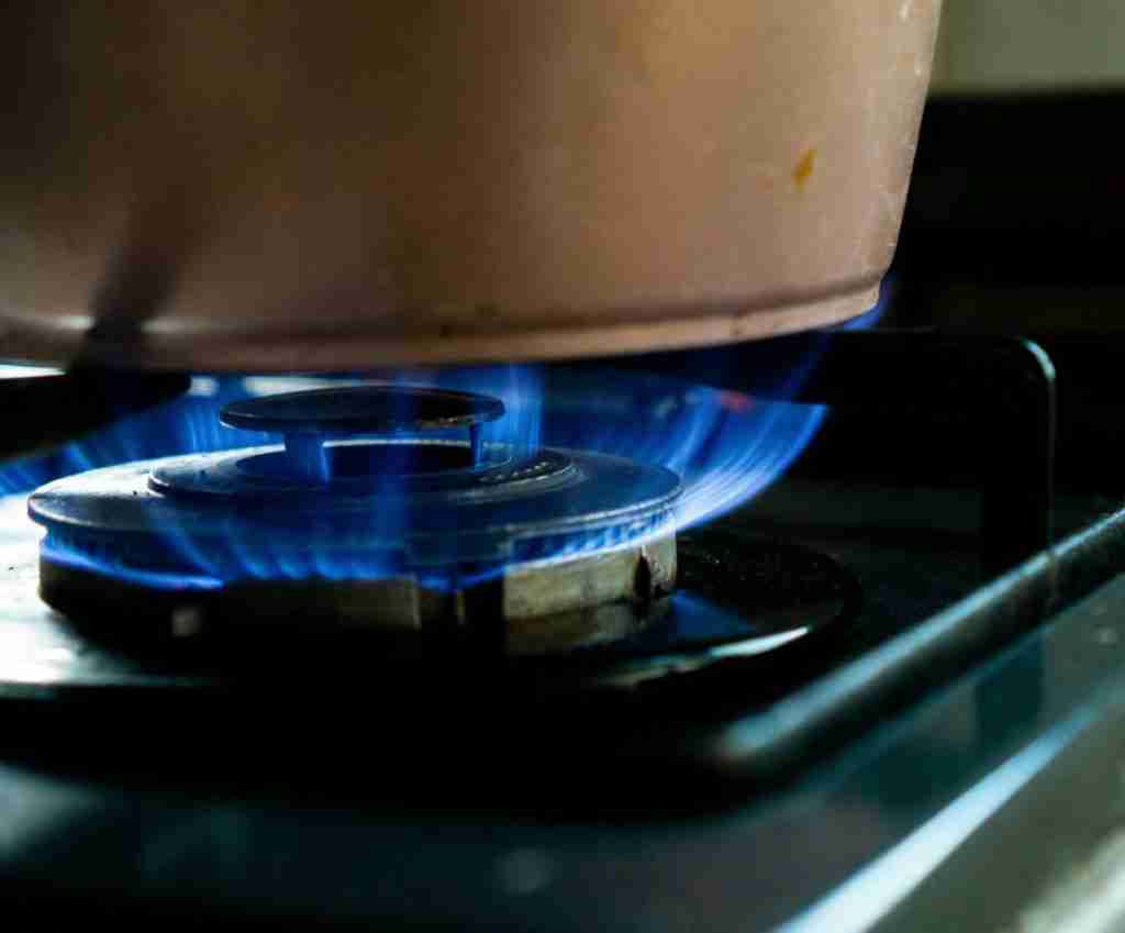Pan on a lit gas hob.