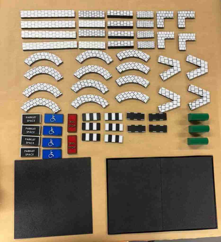Photo shows model piese that Nicholas has developed to help Disabled people see and hold different types of street design proposals such as kerbs, surfacing and street furniture. He has been working on this with the Accessibility Working Group.