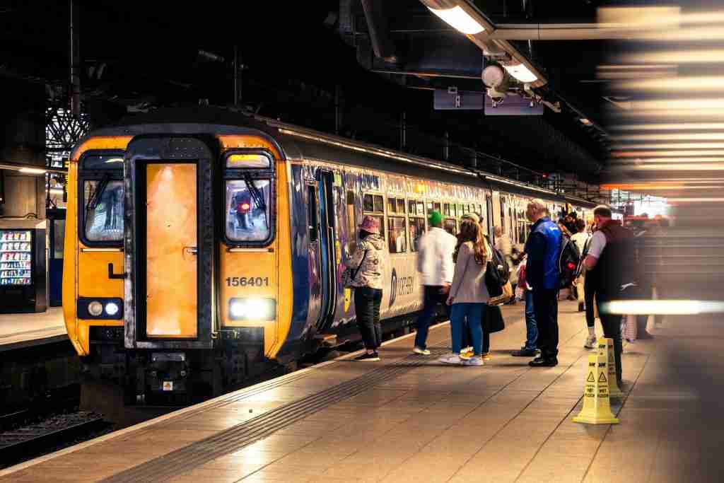A group of people are getting on a train.